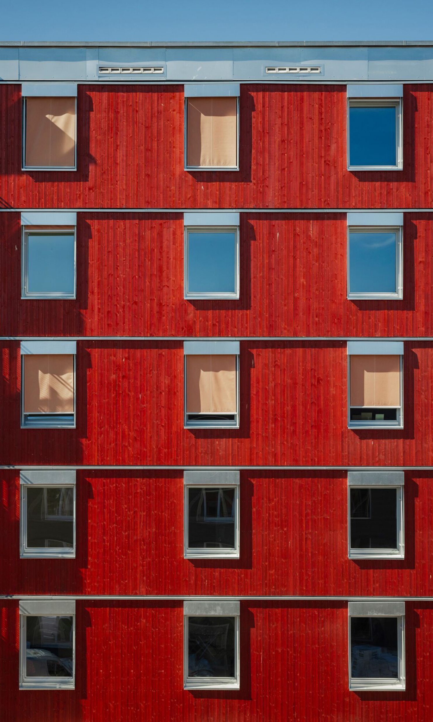 Fenster auf der roten Fassade der Wohnsiedlung Freiham